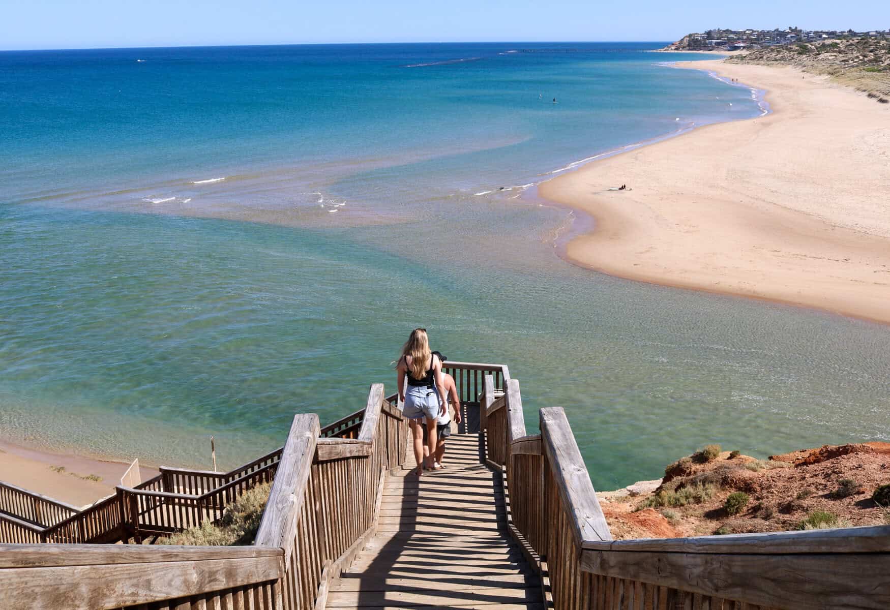 Scenic beach access on the Fleurieu Peninsula, South Australia, with wooden stairs leading to a secluded shoreline, turquoise water, and coastal views.