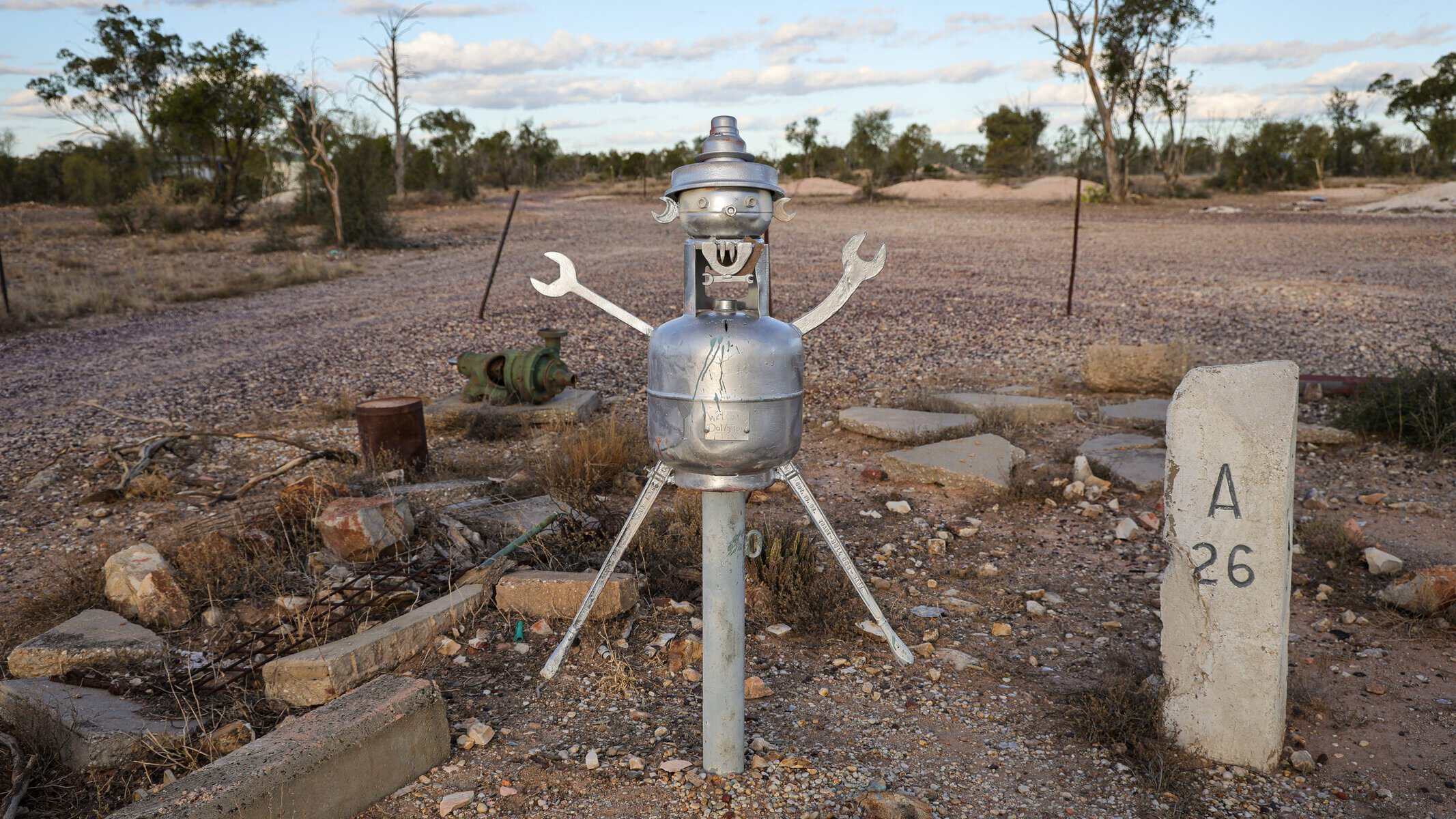 Quirky metal sculpture beside a mine shaft marker on the opal fields of Lightning Ridge, New South Wales